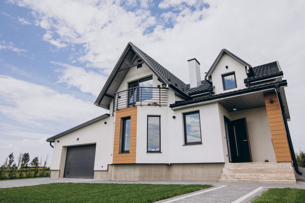 Two-story house with white walls and wood accents.